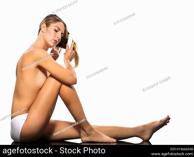Sensuous woman combing hair