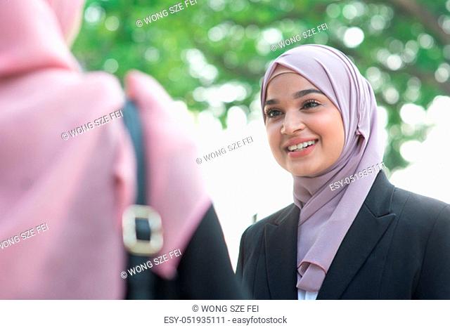 Beautiful Muslim business woman talking and smile