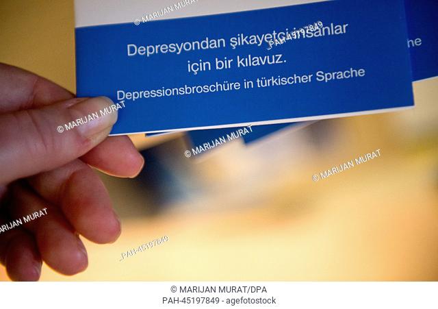(ILLUSTRATION) A woman takes a brochure of a pharmaceutical company which informs about depression in turkish language from a pile at the psychiatric...