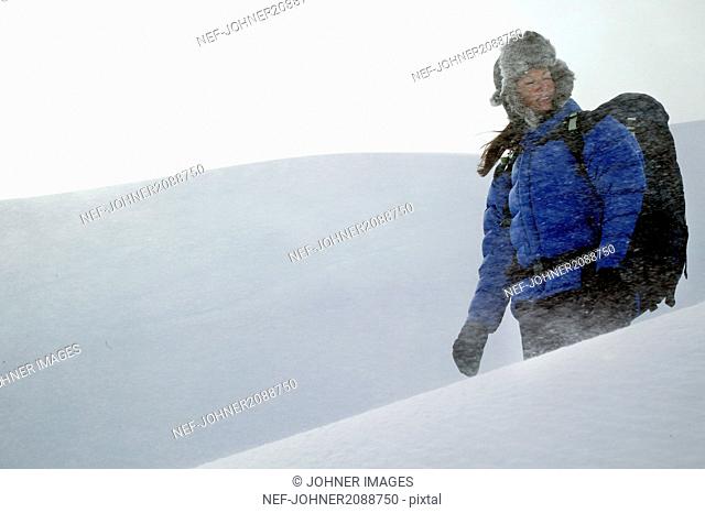 A woman walking in a snowstorm
