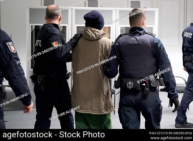 19 December 2023, Schleswig-Holstein, Itzehoe: The defendant Ibrahim A. (M) is brought into the courtroom at the China Logistic Center in handcuffs