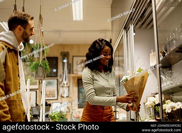 Woman buying flowers in shop