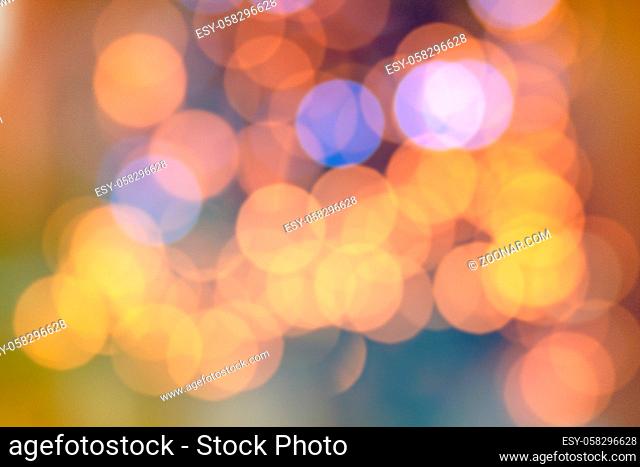 Background overlay of a soft defocused bokeh of a colourful lights on a Christmas tree