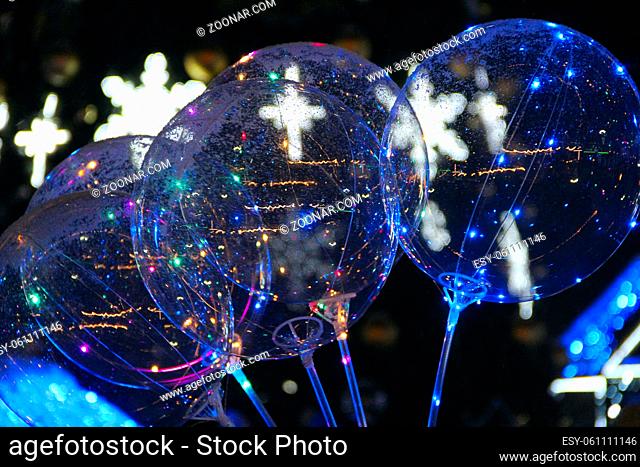Transparent balloons with shiny lights at New Year party. Christmas and New Year's winter holiday lights. Garland lights toys