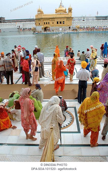 Sikh devotees walks around Golden temple ; Amritsar ; Punjab ; India