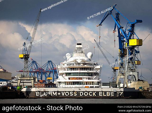 dpatop - 20 May 2021, Hamburg: The cruise ship ""AIDAaura"" is moored in Dock Elbe 17 at the Blohm+Voss shipyard. In addition to the renewal of the underwater...
