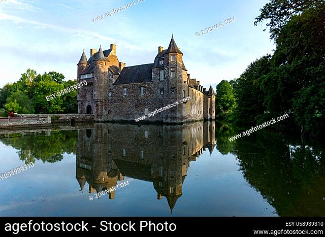 Campeneac, Brittany / France - 26 August 2019: Trecesson Castle in the pond and moat and surrounded by forest