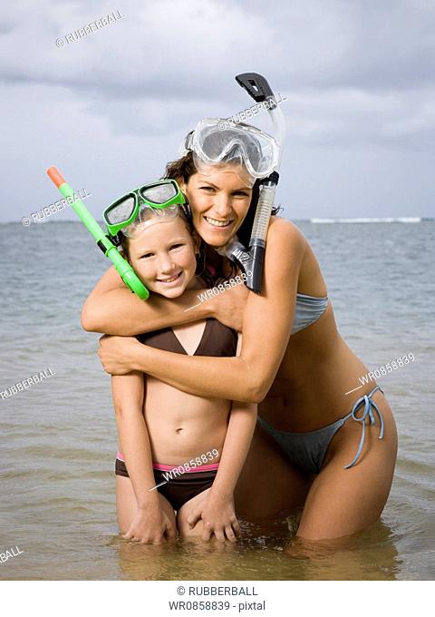 Close-up of a mother and daughter wearing snorkel gear