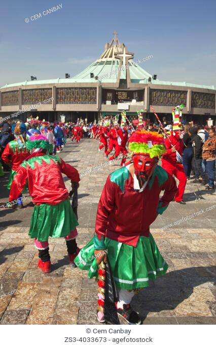 Indigenous dancers wearing masks performing during the celebrations in front of the Basilica on the festival day dedicated to Our Lady of Guadalupe at Plaza De...