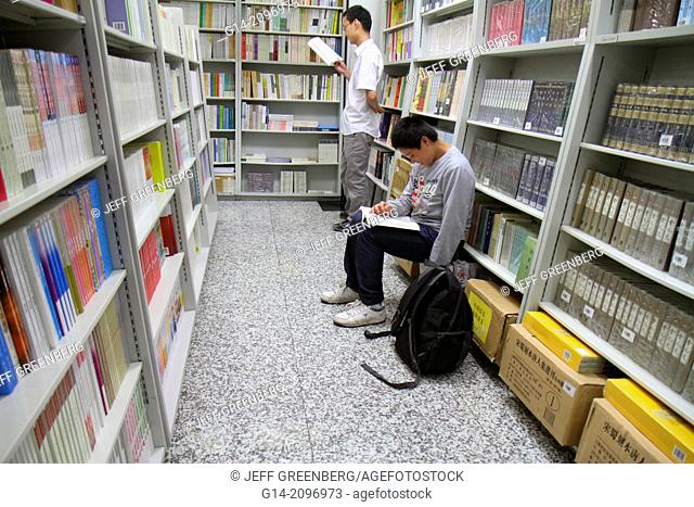 China, Beijing, Wangfujing Xinhua Bookstore, shopping, inside, sale, books, shelves, Asian, man, browsing, teen, boy, Chinese characters hànzì pinyin