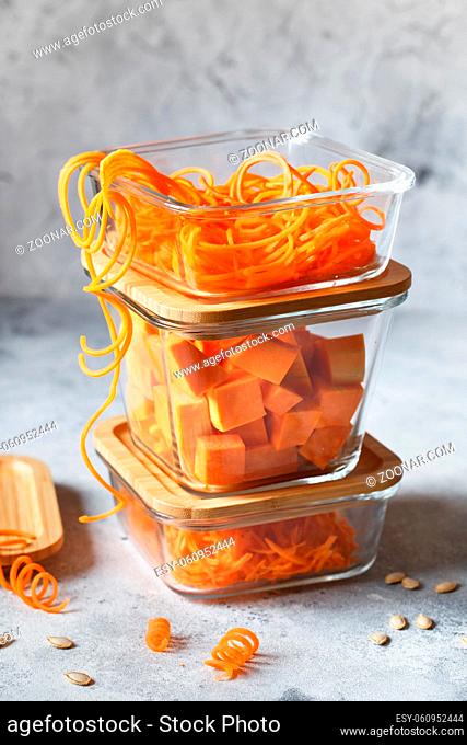 Glass boxes with fresh raw orange vegetables. Finaly shredded pumpkin and big pieces. Healthy Meal Prep, recipe preparation photos