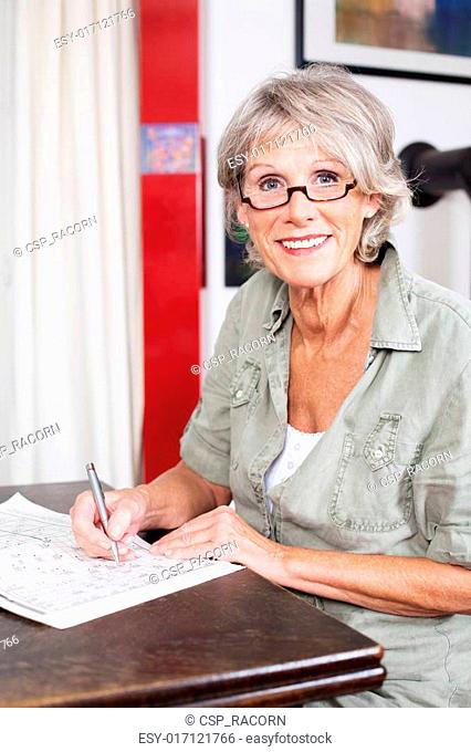 Senior woman completing a crossword puzzle