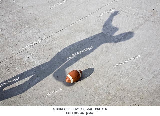 Shadow throwing an American football