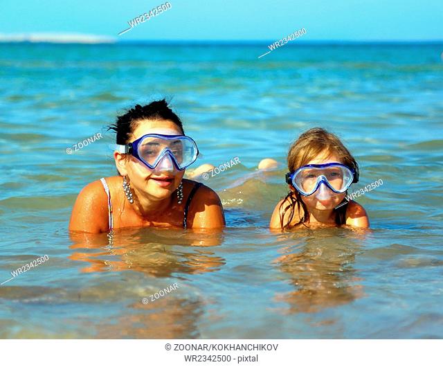 Vacation - snorkeling daughter with mother