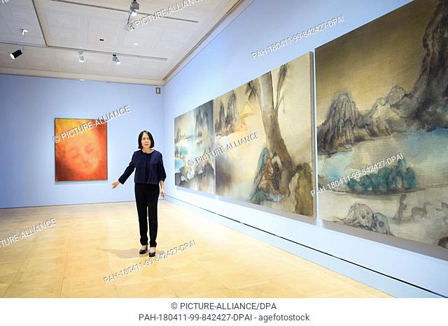 10 April 2018, Germany, Berlin: Artist Leiko Ikemura walks past the artistic works titled 'Marian' (L-R), 'Tokaido', 'Genesis' and 'Tokaido' at the exhibition...