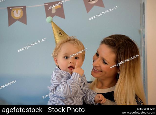 Toddler celebrates his 1st birthday on the mother's arm, Stuttgart, Baden-Wurttemberg, Germany