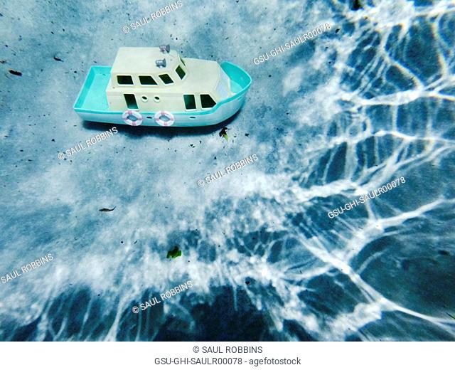 Plastic Toy Boat at Bottom of Swimming Pool