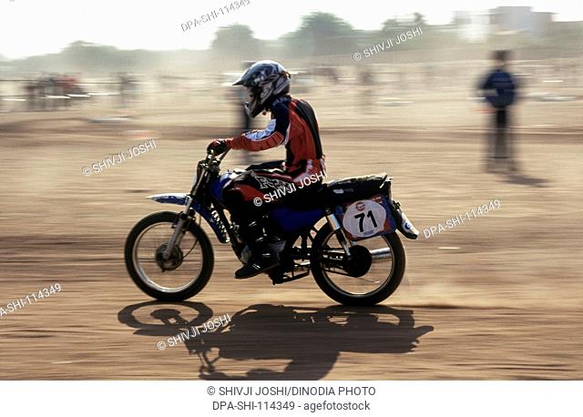 Racing ; rider speeding dirt bike in gulf national bike competition ; Jodhpur ; Rajasthan ; India