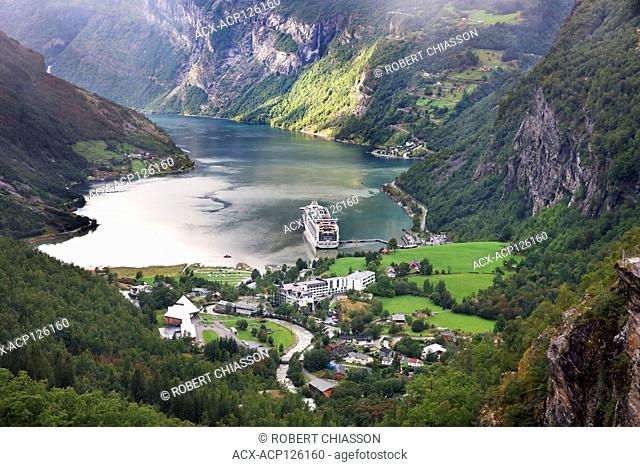Panoramic view of the village of Geiranger, a cruise ship and the surrounding fjord (Geirangerfjord) as seen from the lookout Flydalsjuvet, Geiranger, Norway