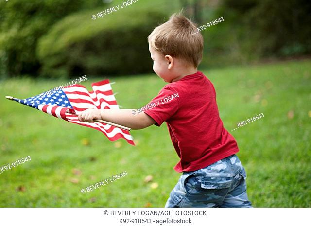 Child carrying an American flag