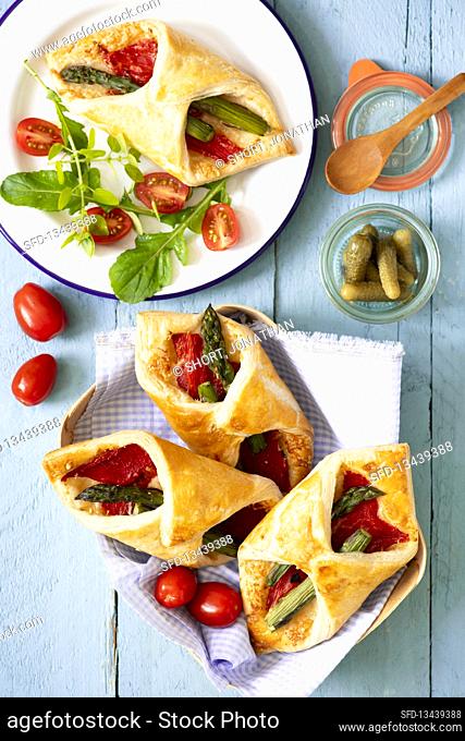 Savoury puff pastries with roasted peppers, asparagus and Parmesan
