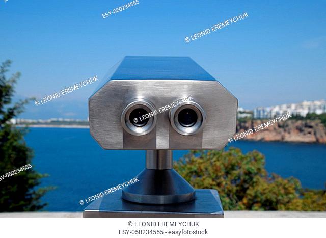 Inspection binoculars on the waterfront. Inspection of the Antalya embankment through the viewing binoculars