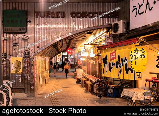 Night view of Yurakucho Concourse underpass under the railway line of the station Yurakucho. Japanese noodle stalls and sake bars revive the nostalgic years of...