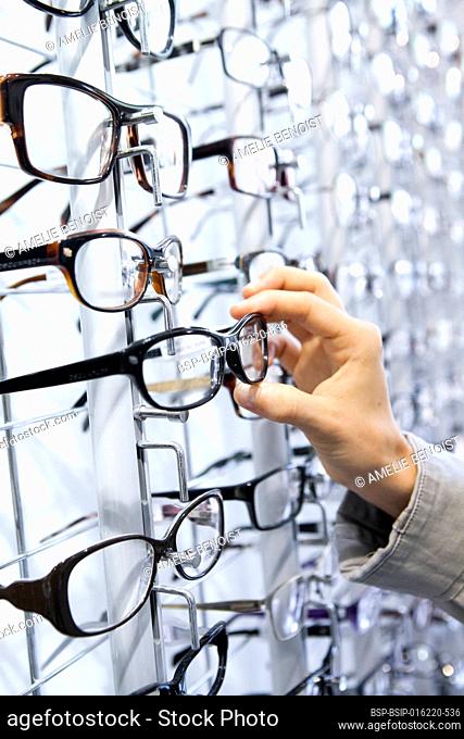 Woman choosing glasses at an optician