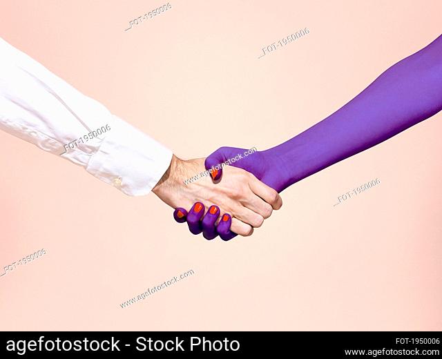 Abstract handshake on pink background