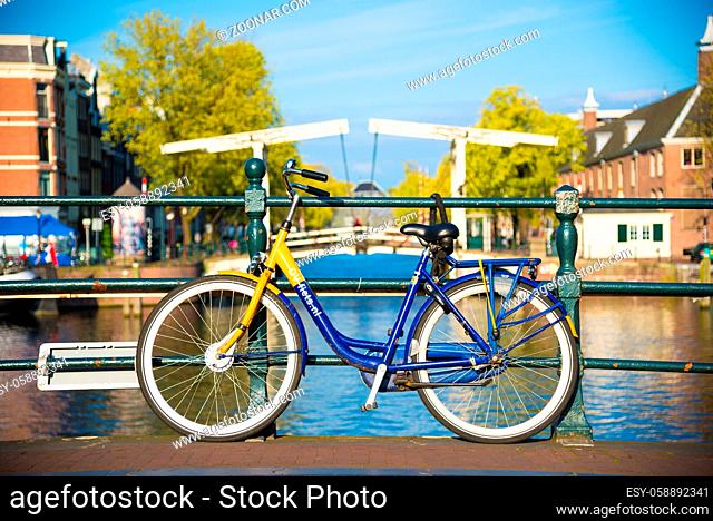 Amsterdam, Netherlands - April 19, 2017: Bicycles parked on a bridge in Amsterdam, The Netherlands