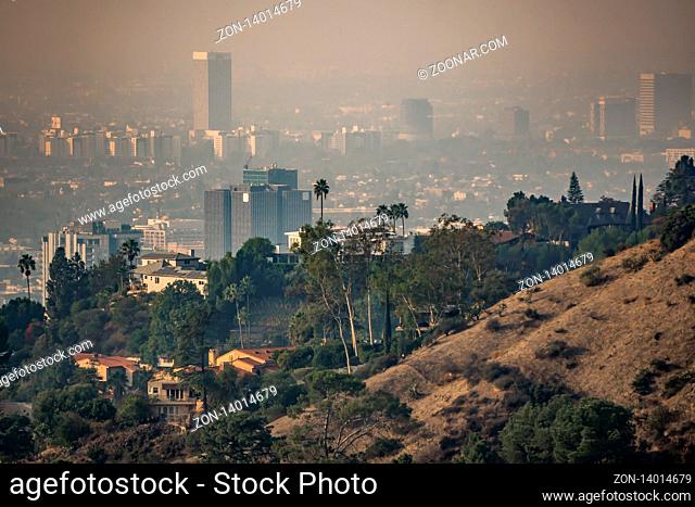 los angeles skyline and suburbs wrapped in smoke from woosle fires in 2018