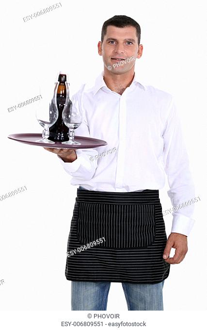 waiter holding tray with glasses and bottle