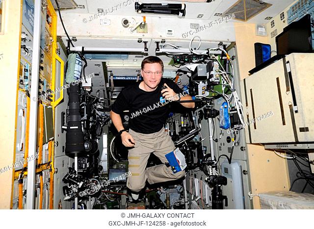 NASA astronaut Doug Wheelock, Expedition 24 flight engineer, uses a ham radio system in the Zvezda Service Module of the International Space Station