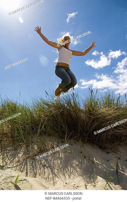 A young woman jumping Skane Sweden