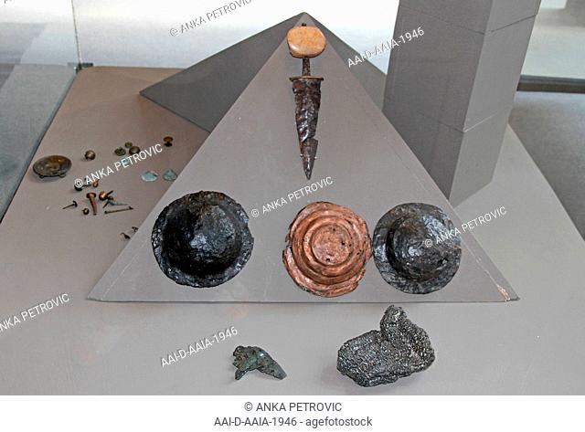 Collection of metallic ornaments in glass casing display, National Archaeological Museum Djerdap, Kladovo, Serbia