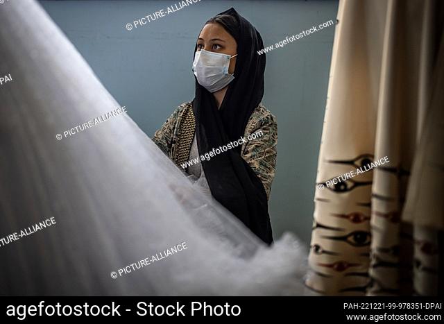 08 November 2022, Afghanistan, Kabul: A young Afghan woman works on a dress by Laila Haidari. In western Kabul, Haidari has founded an institute where women...