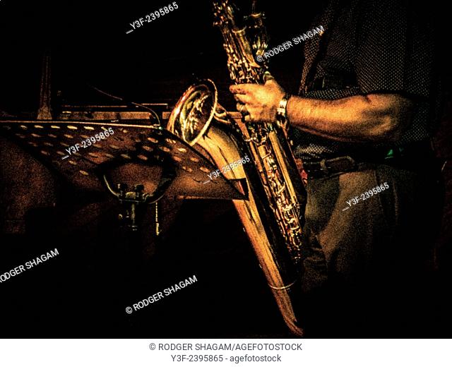 Music. A saxophonist in a jass quartet shows his skills