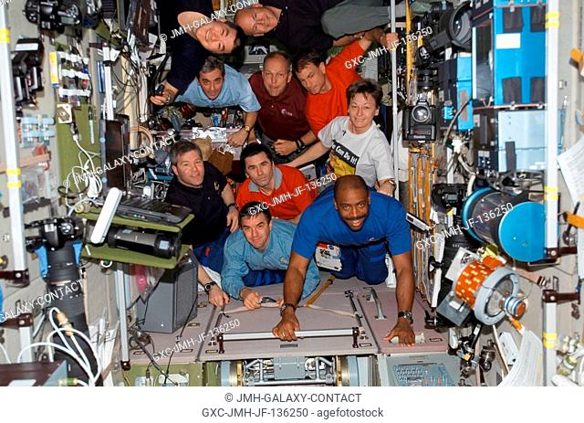 The STS-122 and Expedition 16 crewmembers gather for a photo in the Zvezda Service Module of the International Space Station