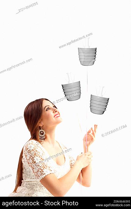Woman holds rope connected light bulbs balloon shape, isolated on white background