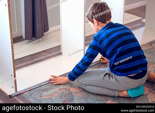 Hobby, carpentry, woodwork, craft, skill concept - boy making constructing assembling furniture at home