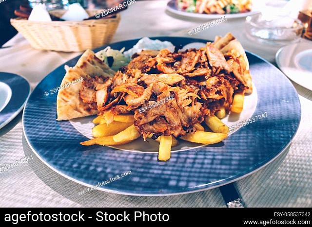 Greek food, chicken and pork mixed gyros on plate