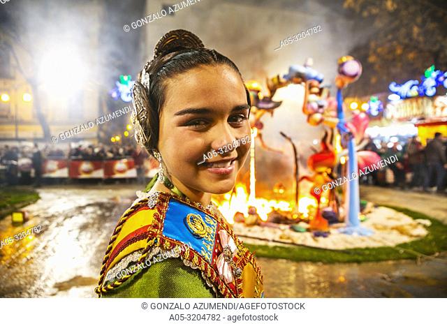 Fallas festival. Fallera. Child in traditional dress. La Crema. The Burning. On 19 March all of the sculptures go up in flames