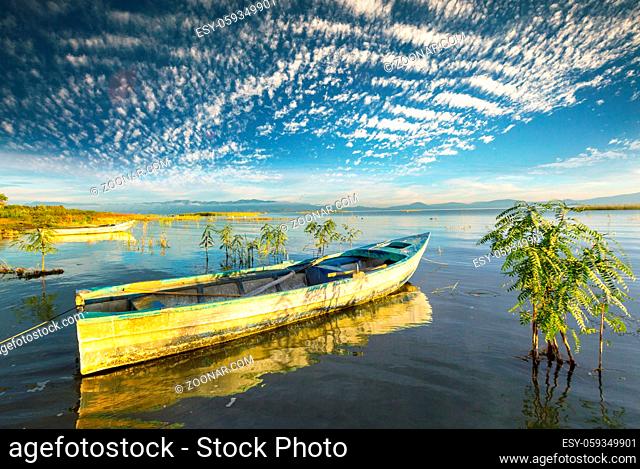 Boat on lake at beautiful sunrise