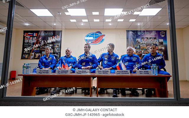Expedition 50 prime and backup crews are seen in quarantine behind glass during a crew press conference, from left, NASA astronaut Peggy Whitson
