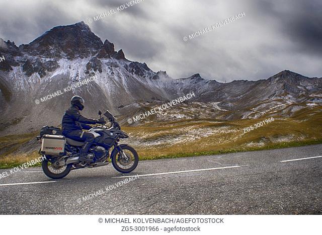 motorcyclist drives by the Col du Vallon, Valloire, Auvergne-Rhone-Alpes, France in September
