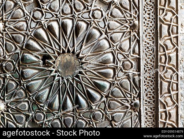 Ornaments of the bronze-plate ornate door of Sultan Barkouk Mosque, an ancient historic mosque in Old Cairo, Egypt