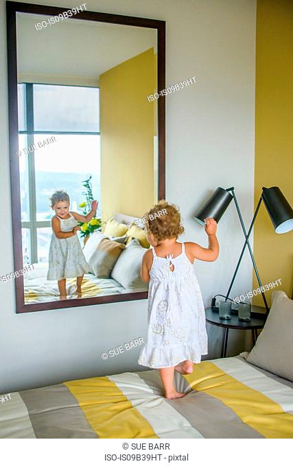 Girl dancing in front of mirror in bedroom