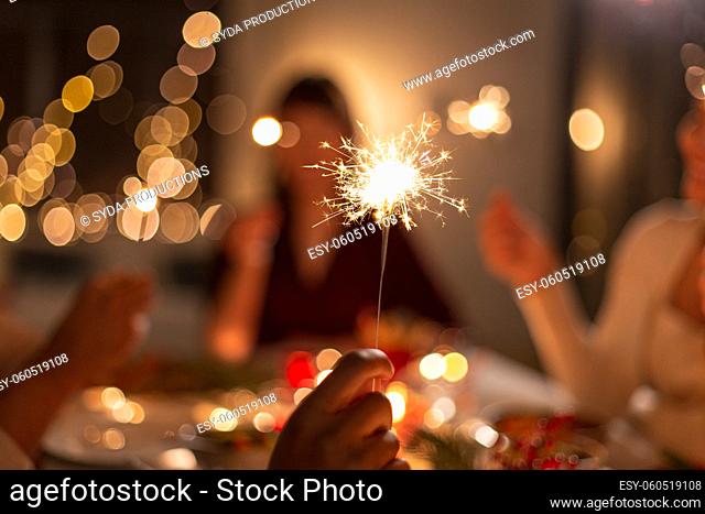 close up of hand with sparkler at christmas party