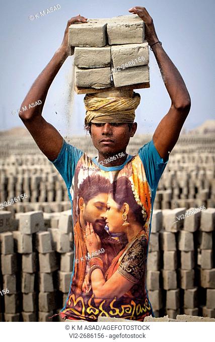 Robin (14) works in a brickfield covered with thick dust in Dhaka, Bangladesh, January 18, 2016. In this brickfield burning coal causes tremendous production of...