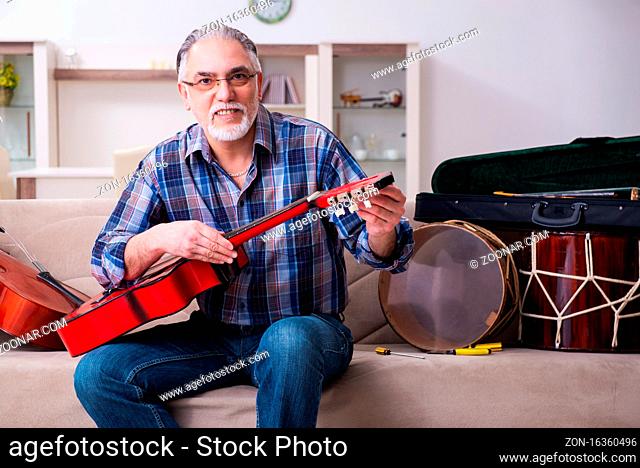 Senior repairman repairing musical instruments at home